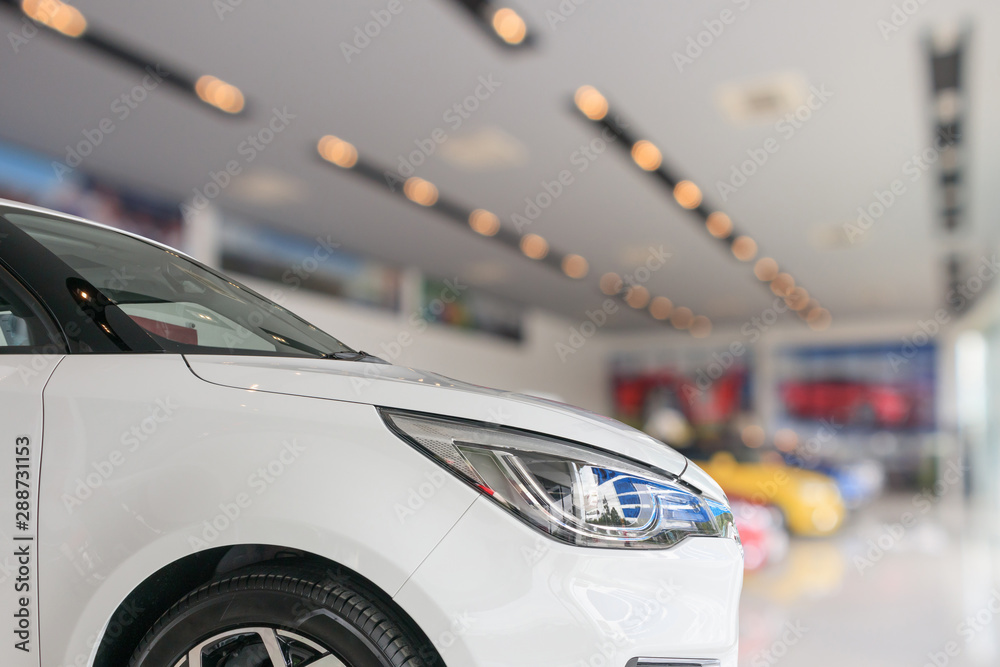 Fototapeta premium closeup front of new car in showroom background