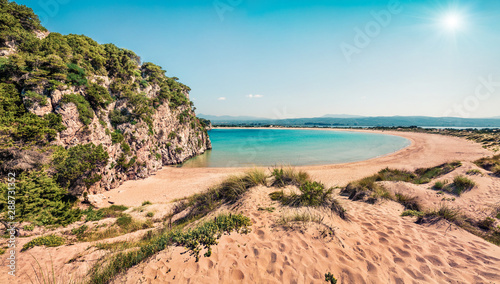 Stunning spring view of Voidokilia beach. Sunny morning seascape of Ionian Sea, Pilos town location, Greece, Europe. Beauty of nature concept background. Artistic style post processed photo.