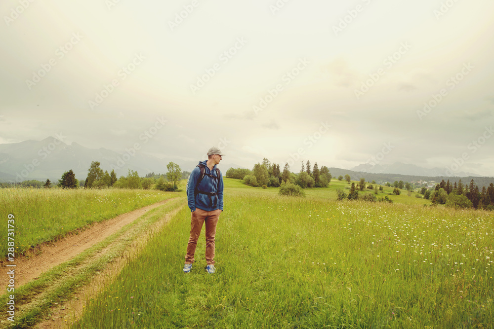 Traveler Man with backpack mountaineering