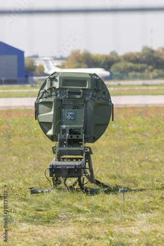 A military green radar on the field