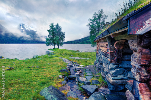 Foggy summer view of the Innerdalsvatna lake. Colorful morning scene in Norway, Europe. Beauty of countryside concept background. Instagram filter toned. photo