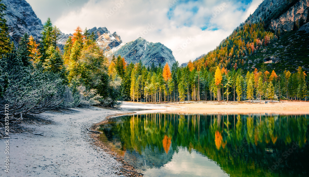 First snow on Braies Lake. Colorful autumn landscape in Italian Alps, Naturpark Fanes-Sennes-Prags, Dolomite, Italy, Europe. Artistic style post processed photo. - obrazy, fototapety, plakaty 