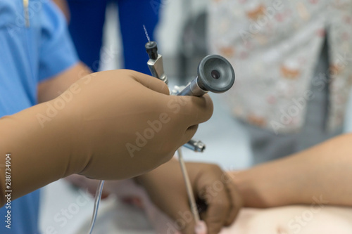 A team of urologist doctors performing a cystoscopy using a cystoscope. In a sterile operating room. close-up photo