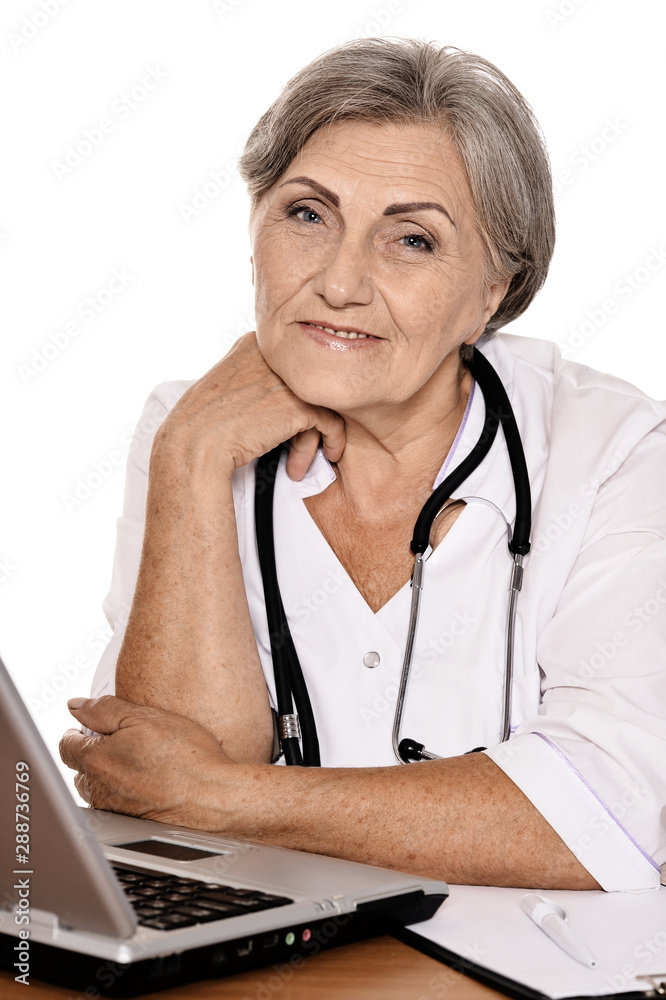 Portrait of confident female doctor sitting at table Portrait of confident female doctor sitting at table