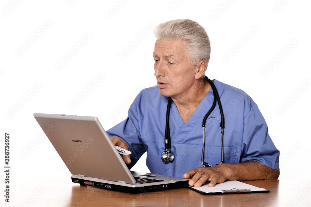 Elderly doctor with a laptop on white background Elderly doctor with a laptop on white background