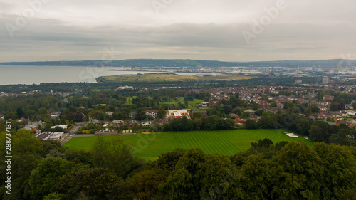 Countryside, aerial view on houses near coast of Irish sea in Belfast Northern Ireland. Cloudy sky above seaside 