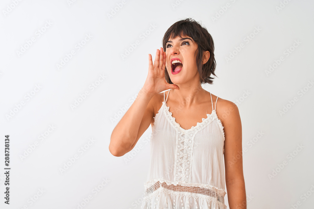 Young beautiful woman wearing summer casual t-shirt standing over isolated white background shouting and screaming loud to side with hand on mouth. Communication concept. Young beautiful woman wearing summer casual t-shirt standing over isolated white background shouting and screaming loud to side with hand on mouth. Communication concept.