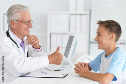 Portrait of happy young family visiting doctor