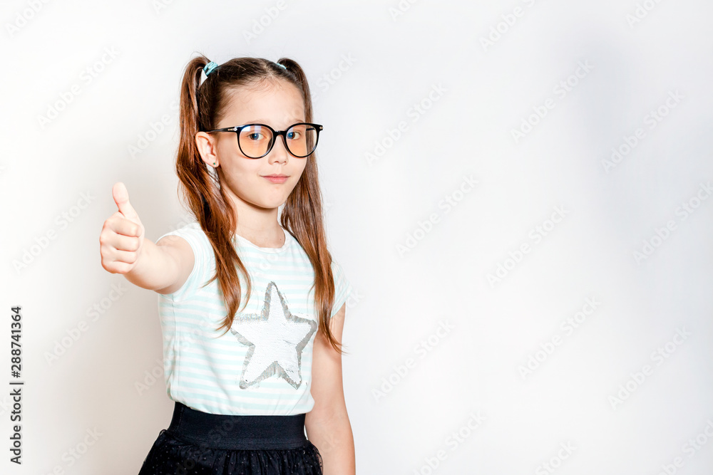 The little girl shows her finger up The little girl shows her finger up