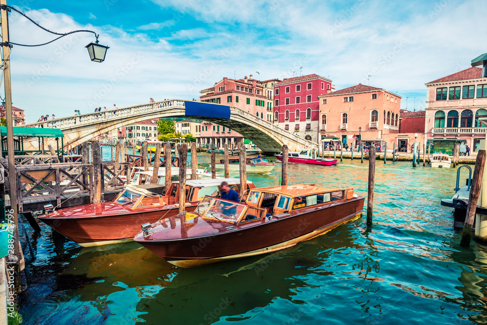 Bright spring view of Vennice with famous water canal and Scalzi Bridge. Splendid morning scene of Italy, Europe. Magnificent Mediterranean cityscape. Traveling concept background.