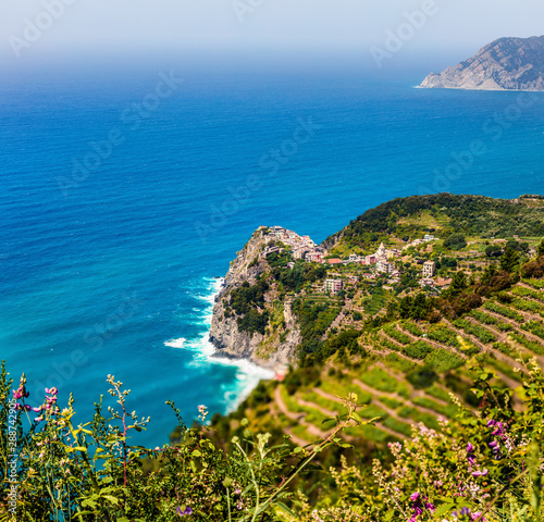 Third village of the Cique Terre sequence of hill cities - Corniglia. Colorful spring morning in Liguria, Italy, Europe. Picturesqie seascape of Mediterranean sea. Traveling concept background. photo