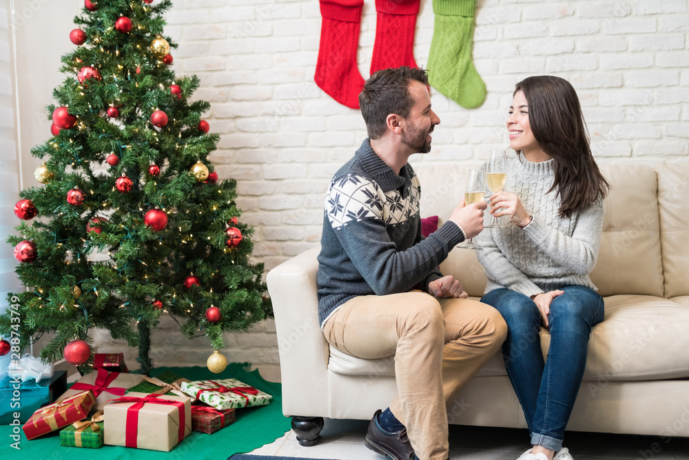 Partners Having Champagne At Home During Christmas