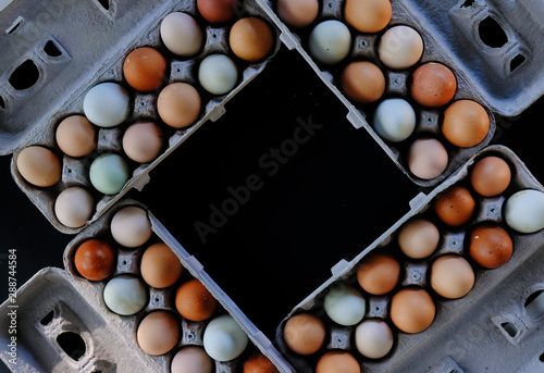 Earthy tones of chicken eggs in carton, copy space for farm harvest or grocery concept.