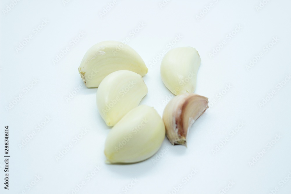 Garlic cloves are located on a white background. Garlic cloves are located on a white background.