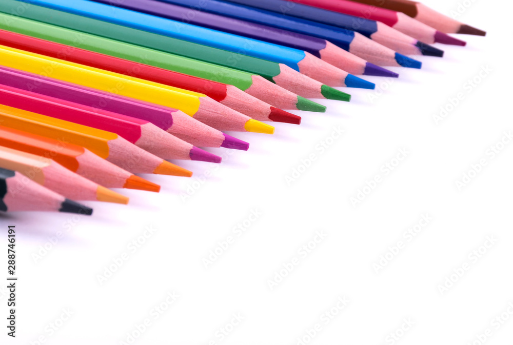 Colored sharpened wooden pencils lie on a white sheet of paper for creativity, drawing, notes, texts and letters