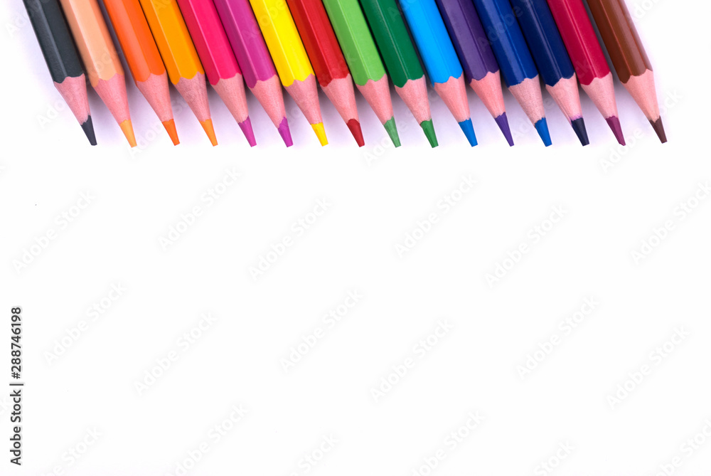 Colored sharpened wooden pencils lie on a white sheet of paper for creativity, drawing, notes, texts and letters Colored sharpened wooden pencils lie on a white sheet of paper for creativity, drawing, notes, texts and letters