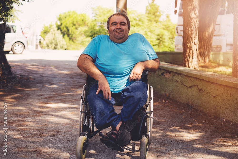 disabled man in wheelchair walking park - obrazy, fototapety, plakaty 