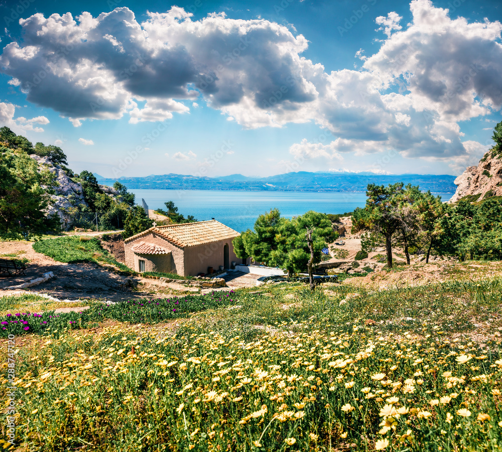Sunny spring scene of Agios Ioannis Church. Splendid morning view of West Court of Heraion of Perachora, Limni Vouliagmenis location, Greece, Europe. Traveling concept background. Sunny spring scene of Agios Ioannis Church. Splendid morning view of West Court of Heraion of Perachora, Limni Vouliagmenis location, Greece, Europe. Traveling concept background.