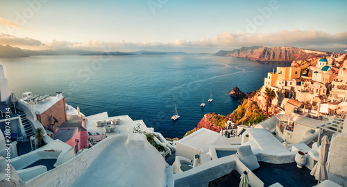 Sunny morning view of Santorini island. Picturesque spring sunrise on the famous Greek resort Oia, Greece, Europe. Traveling concept background. Instagram filter toned.