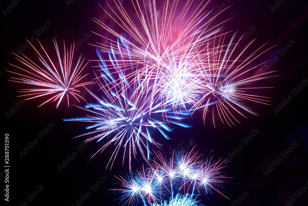 Fireworks on black night sky background. Holiday celebration