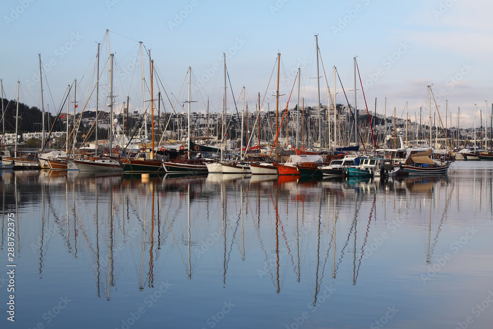marine parking of sailing boats moored in sea dock reflecting in water