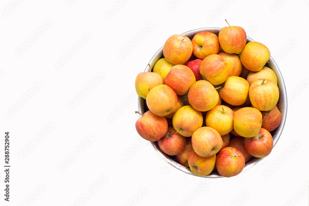 mountain of juicy bright apples in an aluminum basin isolate