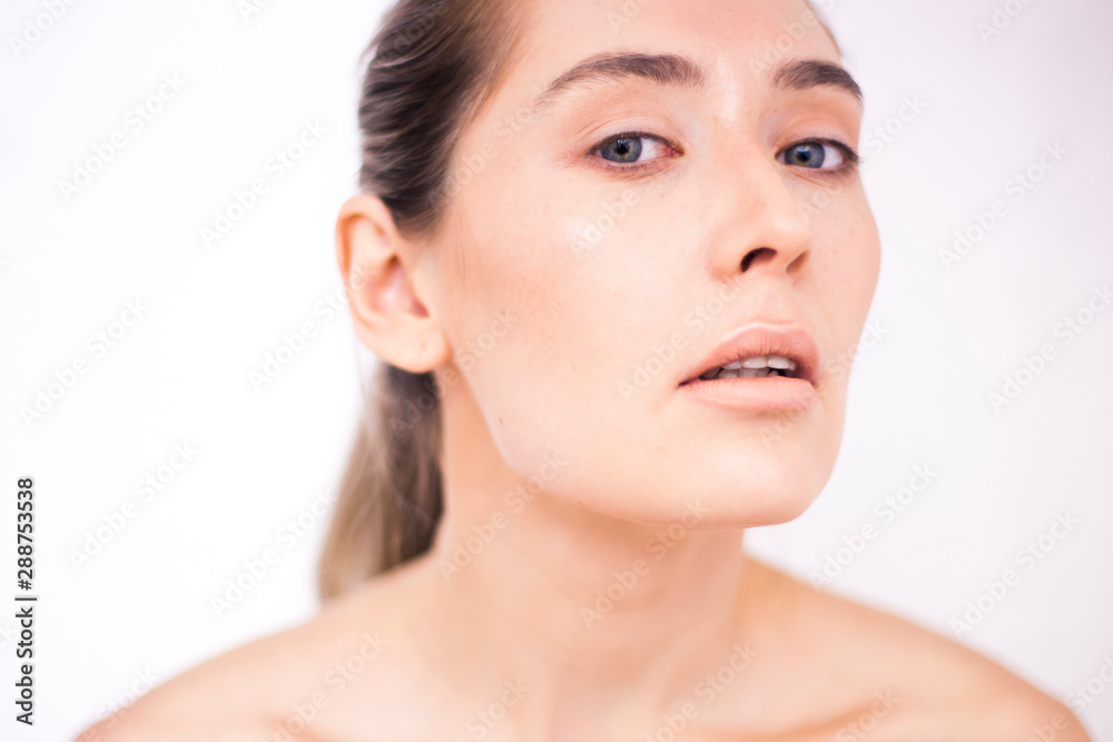 Closeup young woman portrait with clean healthy face. Woman after beautician procedures.