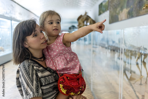 Mother and daughter in museum.