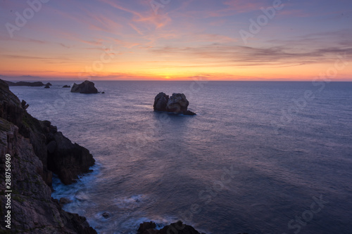 Sunset on the rocky beach © mananuk
