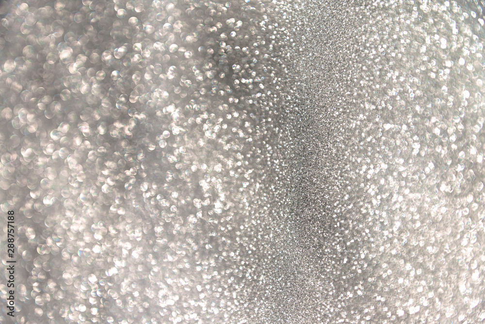 silver festive glittering christmas lights. Blurred gray abstract background for holidays