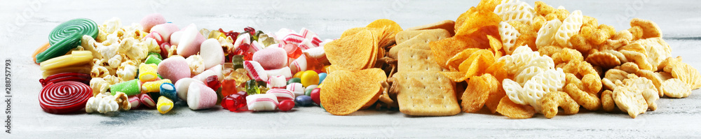 Salty snacks. Pretzels, chips, crackers and candy sweets on table Salty snacks. Pretzels, chips, crackers and candy sweets on table