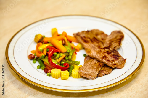 Roast beef with vegetables lie on a plate
