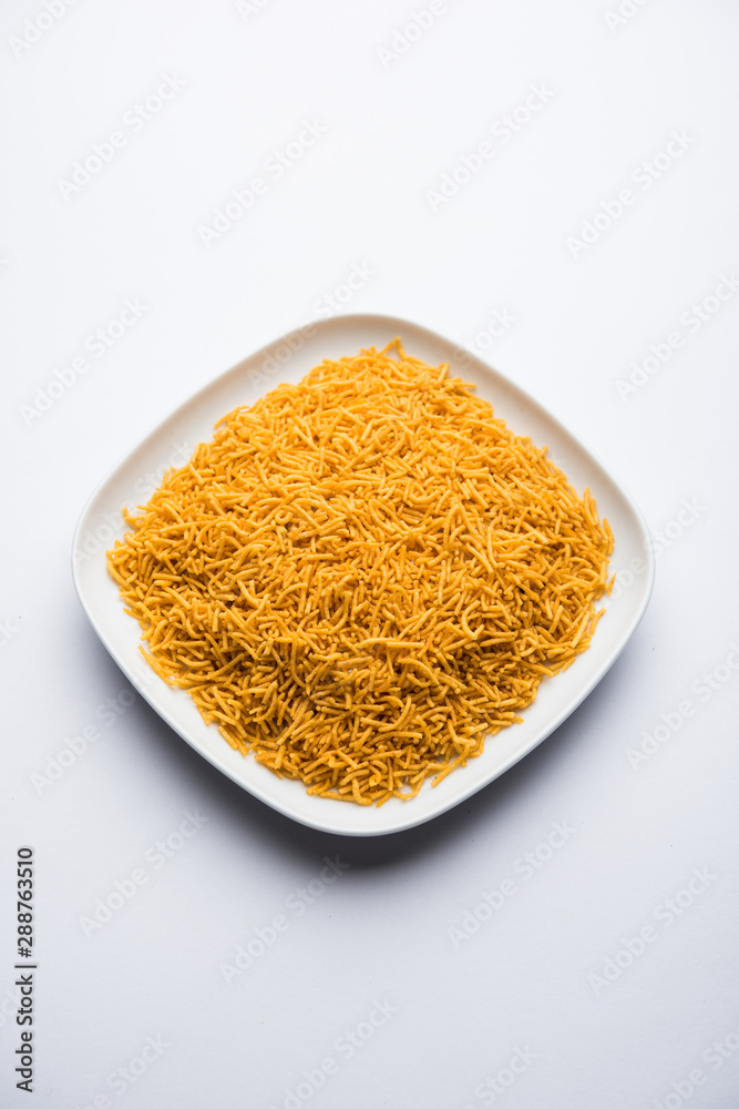 Aloo Bhujiya or Potato Bhujia also known as Namkeen sev. Popular Bikaneri recipe served in a bowl or plate. selective focus Aloo Bhujiya or Potato Bhujia also known as Namkeen sev. Popular Bikaneri recipe served in a bowl or plate. selective focus