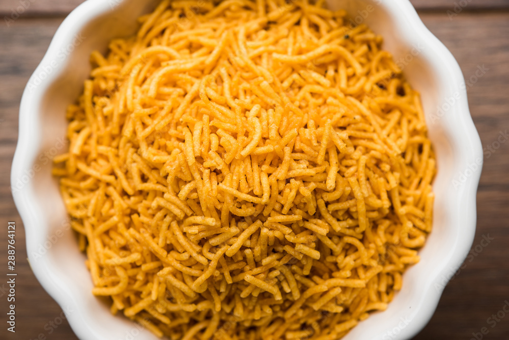 Aloo Bhujiya or Potato Bhujia also known as Namkeen sev. Popular Bikaneri recipe served in a bowl or plate. selective focus Aloo Bhujiya or Potato Bhujia also known as Namkeen sev. Popular Bikaneri recipe served in a bowl or plate. selective focus