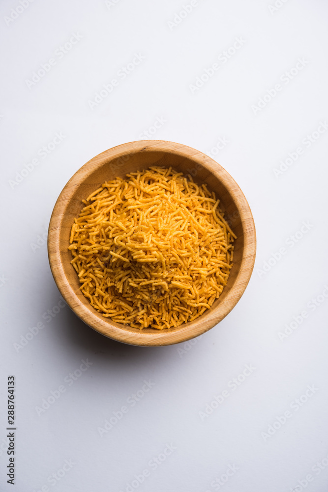 Aloo Bhujiya or Potato Bhujia also known as Namkeen sev. Popular Bikaneri recipe served in a bowl or plate. selective focus Aloo Bhujiya or Potato Bhujia also known as Namkeen sev. Popular Bikaneri recipe served in a bowl or plate. selective focus