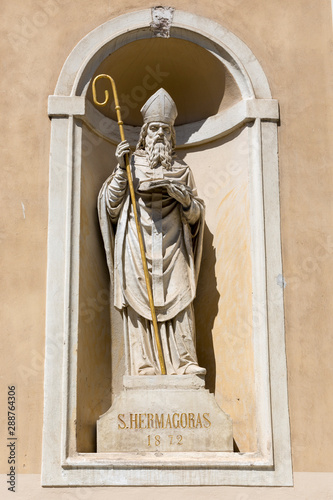 Ljubljana, Slovenia - August 15, 2019: Sculpture of St. Hermagoras of Aquileia on the facade of St. Nicholas Cathedral in Ljubljana photo