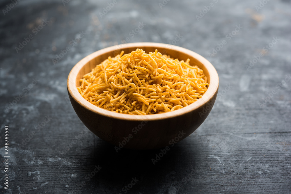 Aloo Bhujiya or Potato Bhujia also known as Namkeen sev. Popular Bikaneri recipe served in a bowl or plate. selective focus Aloo Bhujiya or Potato Bhujia also known as Namkeen sev. Popular Bikaneri recipe served in a bowl or plate. selective focus