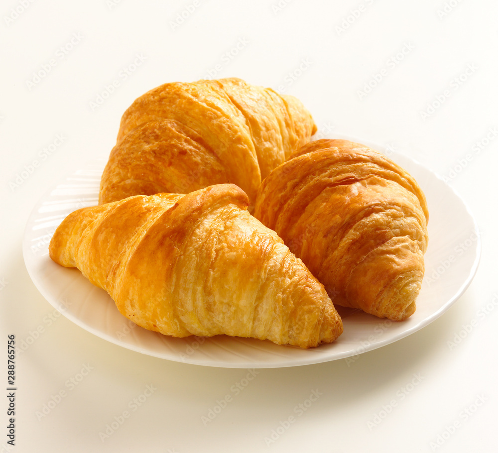 3 Butter Croissants on white Plate on white background