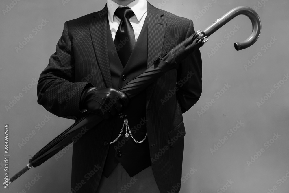 Black and White Portrait of Dapper Businessman in Dark Suit and Leather