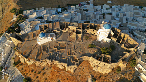 Aerial drone photo of iconic medieval fortified castle overlooking the deep blue Aegean sea in Chora of Astypalaia island, Dodecanese islands, Greece photo