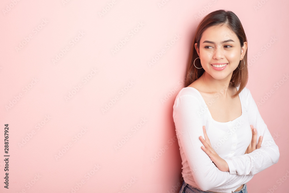 Beautiful university student is smiling on pink background Beautiful university student is smiling on pink background