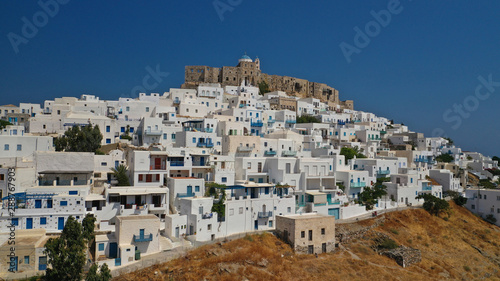 Aerial drone photo of iconic medieval fortified castle overlooking the deep blue Aegean sea in Chora of Astypalaia island, Dodecanese islands, Greece © aerial-drone