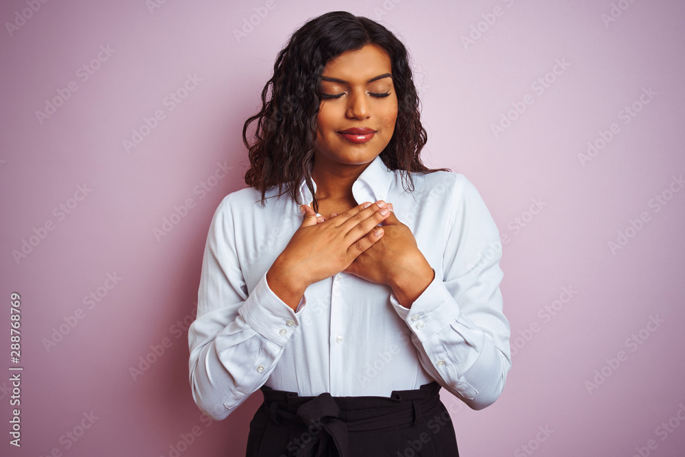 Beautiful transsexual transgender elegant businesswoman over isolated pink background smiling with hands on chest with closed eyes and grateful gesture on face. Health concept.