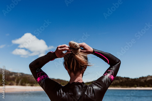 Εκτύπωση καμβά woman in her 40s wearing a neoprene and waiting to swim in the lake