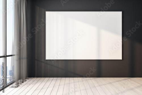 Blank poster on black wall in modern empty room with big windows and wooden floor, mock up. © Who is Danny