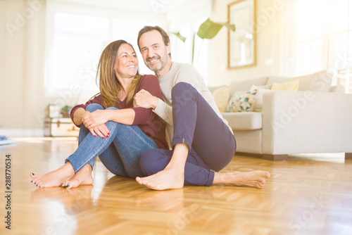 Beautiful romantic couple sitting together on the floor at home © Krakenimages.com