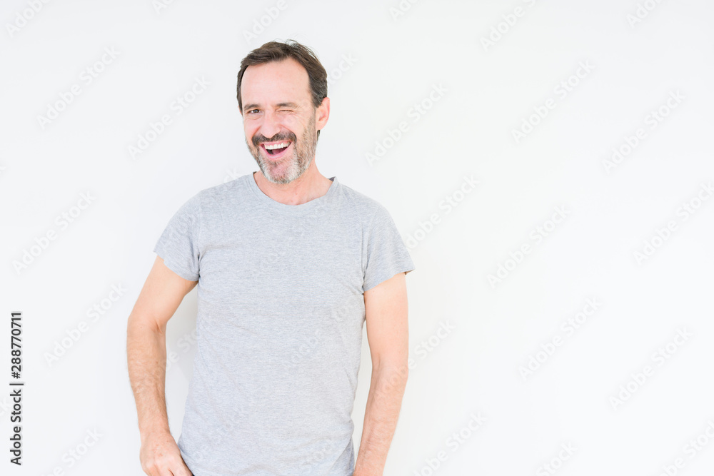 Handsome senior man over isolated background winking looking at the camera with sexy expression, cheerful and happy face. Handsome senior man over isolated background winking looking at the camera with sexy expression, cheerful and happy face.