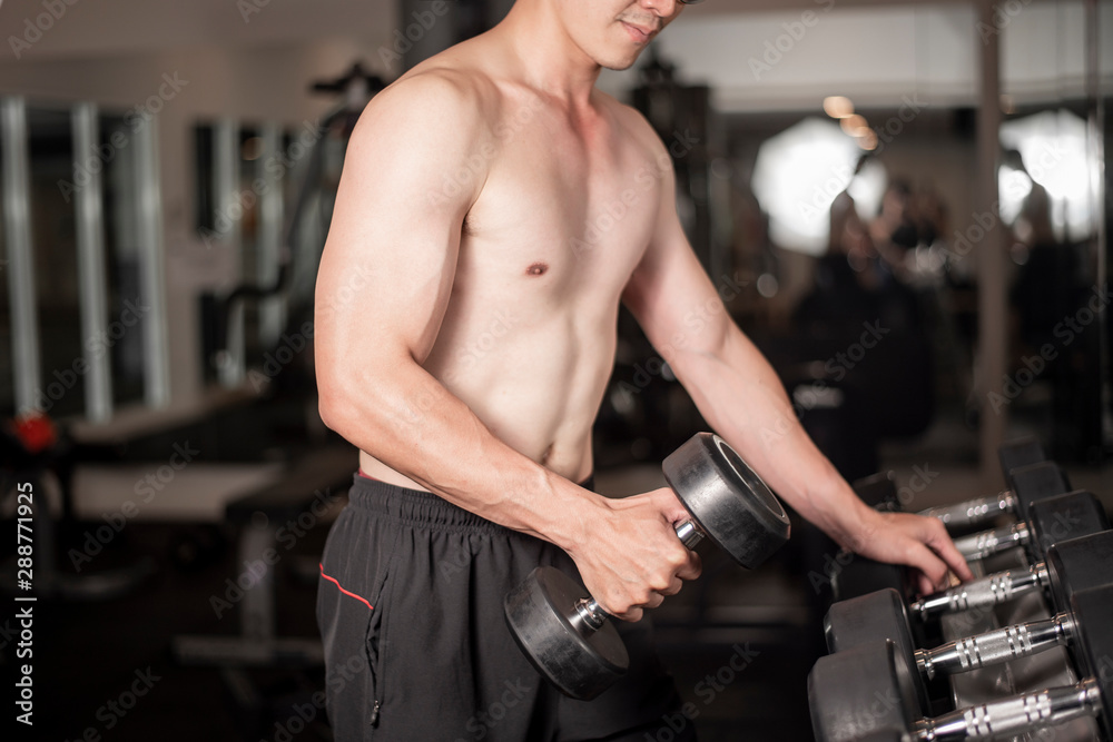Asian man is working out in fitness gym Asian man is working out in fitness gym