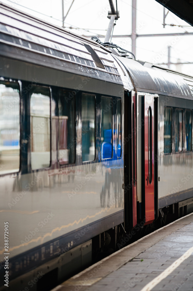Train with open doors on railway station platform in Oostende railway station on Natienkaai 1