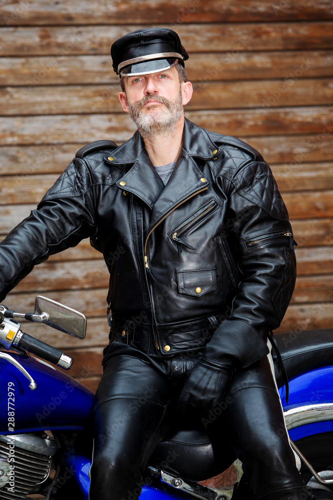 sexy biker dressed in black leather sitting on his bike Stock Photo ...